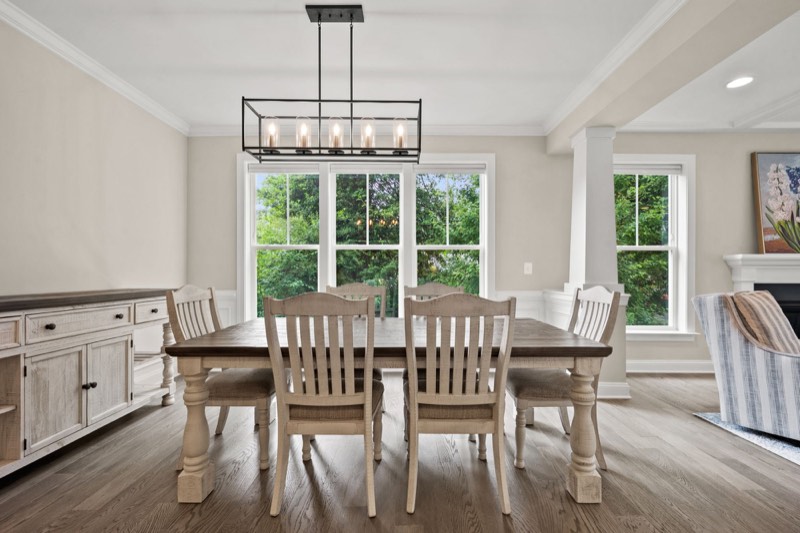 Formal dining room under a linear chandelier